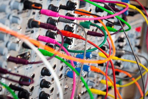 electronic instrumentation with colourful patch wires connecting modules